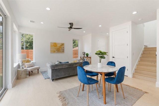 dining room featuring a healthy amount of sunlight, ceiling fan, and light hardwood / wood-style floors