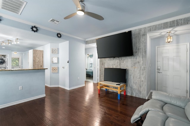 living room featuring washer / dryer, ceiling fan, ornamental molding, and dark wood-type flooring