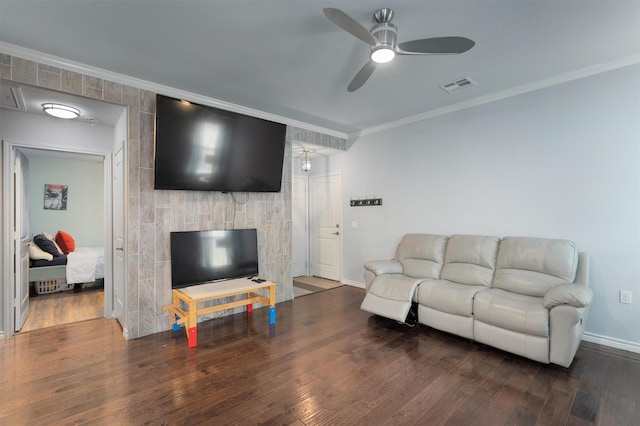 living room featuring ceiling fan, dark hardwood / wood-style flooring, and ornamental molding