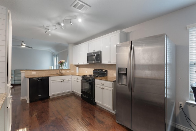 kitchen featuring sink, white cabinetry, black appliances, and kitchen peninsula