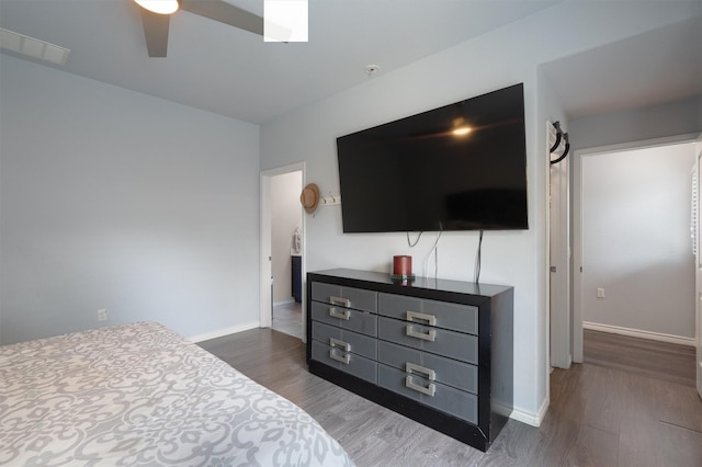 bedroom featuring ceiling fan and dark hardwood / wood-style floors