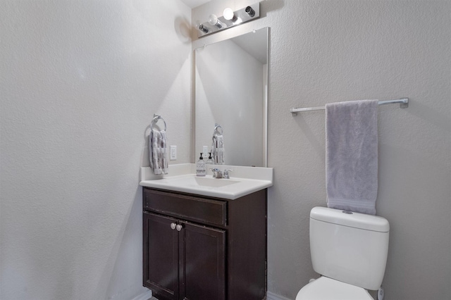 bathroom with toilet and vanity