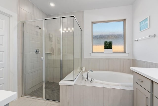 bathroom with independent shower and bath and vanity