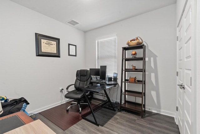 home office with dark hardwood / wood-style floors