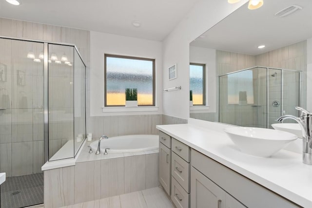 bathroom with vanity and separate shower and tub