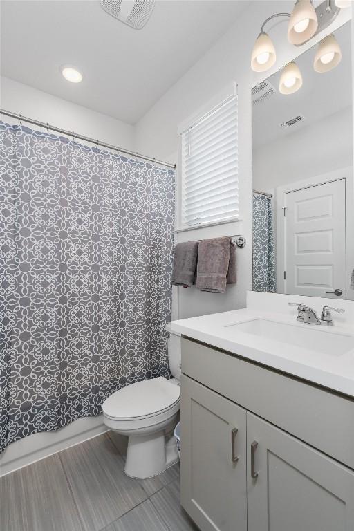 bathroom with vanity, toilet, and a shower with shower curtain