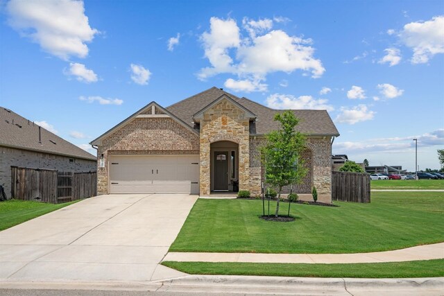 view of front of house featuring a garage and a front yard