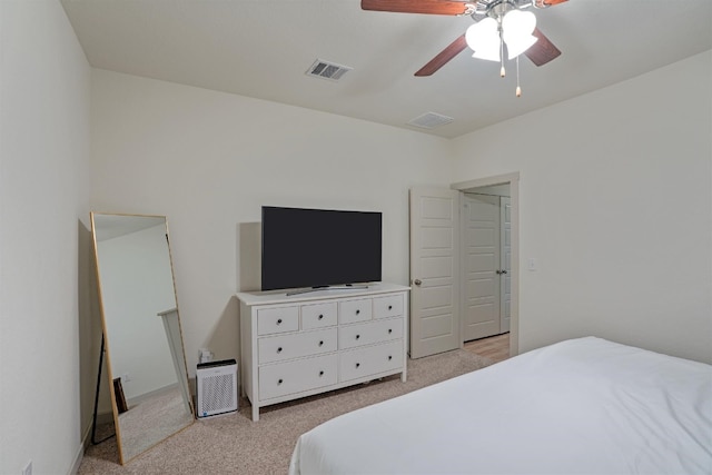 bedroom featuring ceiling fan and light carpet