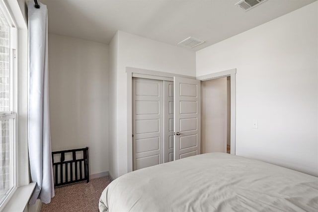 carpeted bedroom featuring a closet