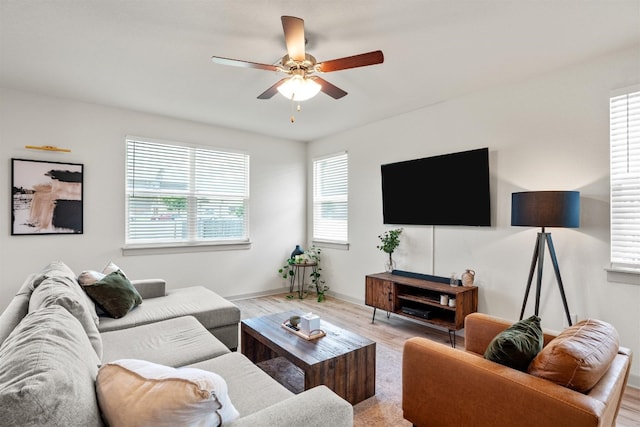 living room with ceiling fan and light hardwood / wood-style floors