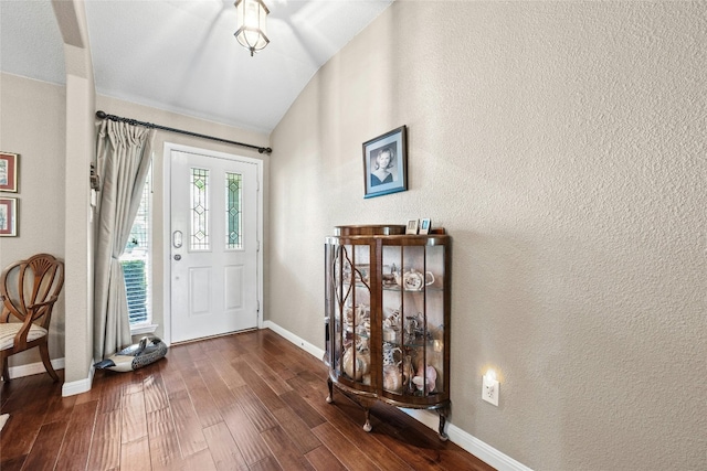 foyer featuring lofted ceiling and dark hardwood / wood-style floors