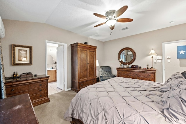 carpeted bedroom with ceiling fan, lofted ceiling, and ensuite bathroom