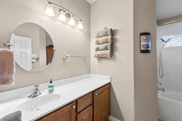 bathroom with vanity and shower / washtub combination