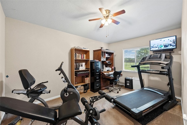 workout room with light carpet, a textured ceiling, and ceiling fan