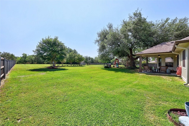 view of yard with ceiling fan and a patio