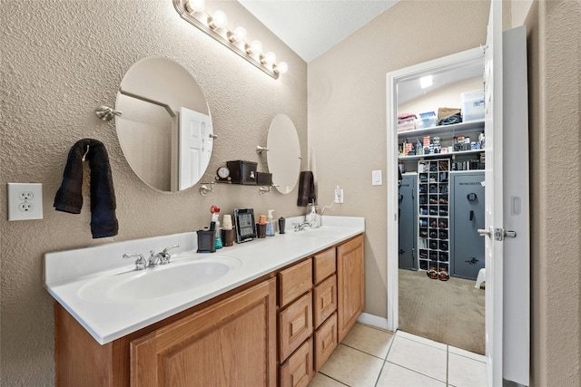 bathroom with tile patterned floors, vanity, and a textured ceiling