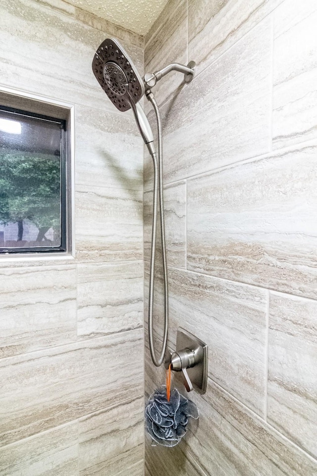 interior details with a tile shower