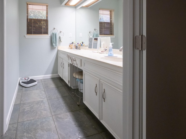 bathroom with vanity, tile patterned floors, and a healthy amount of sunlight