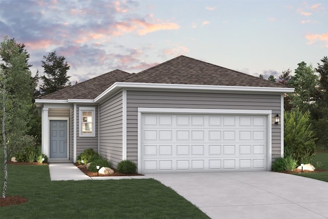 view of front of house featuring a garage and a lawn