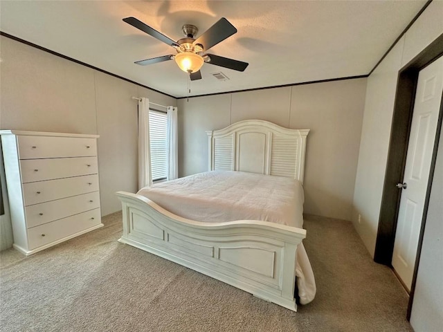 carpeted bedroom featuring ornamental molding and ceiling fan