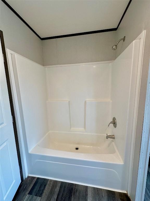 bathroom featuring hardwood / wood-style flooring and bathtub / shower combination