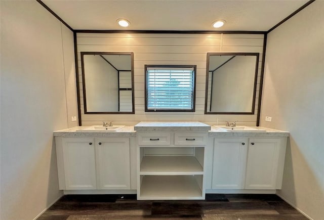 bathroom with vanity, crown molding, and wood-type flooring