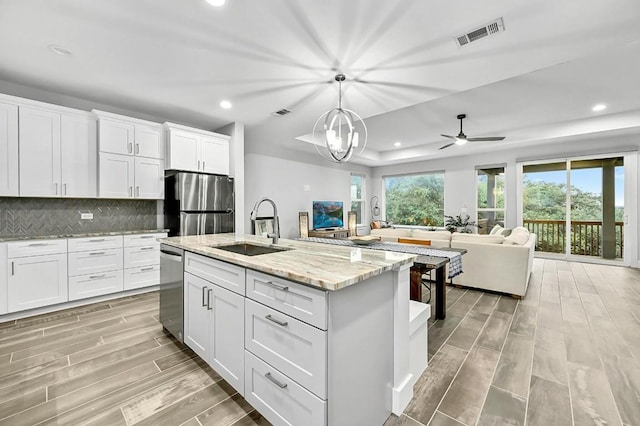 21201 Norris Cv, Lago Vista, TX 78645 - kitchen featuring a sink, stainless steel appliances, light wood-type flooring, recessed lighting, and open floor plan
