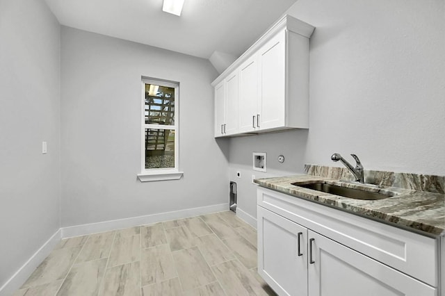 21201 Norris Cv, Lago Vista, TX 78645 - laundry room with electric dryer hookup, hookup for a washing machine, cabinet space, and baseboards