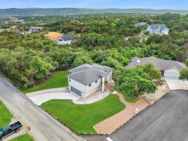 birds eye view of property featuring a residential view and a view of trees