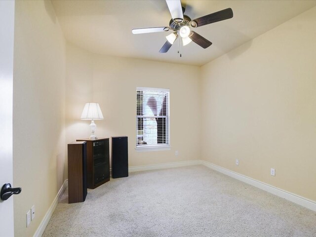 spare room featuring ceiling fan and carpet floors