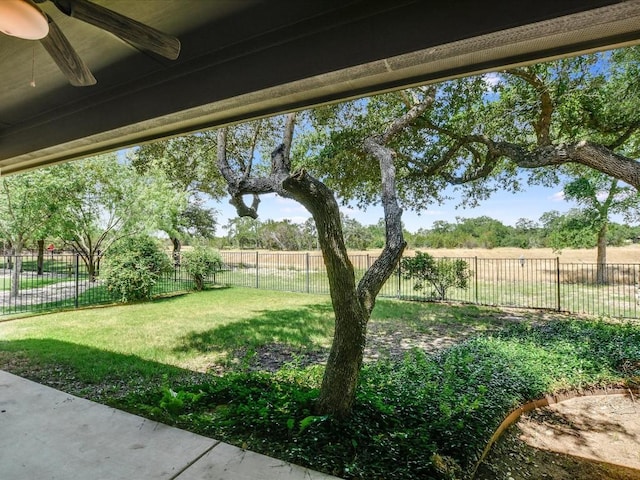 view of yard with ceiling fan and a fenced backyard