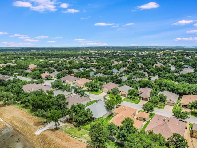 aerial view of property and surrounding area featuring nearby suburban area