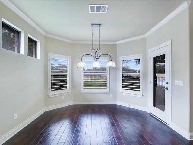 unfurnished dining area featuring a chandelier, hardwood / wood-style floors, crown molding, and baseboards
