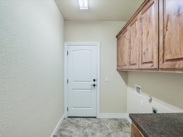 laundry area featuring hookup for a washing machine, hookup for an electric dryer, cabinets, and light tile floors