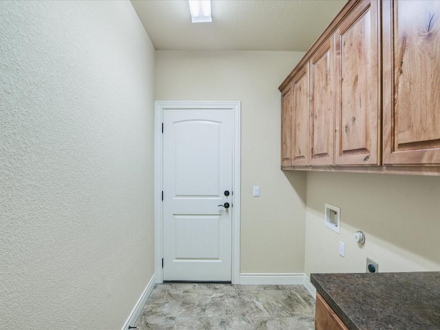 clothes washing area featuring cabinet space, hookup for an electric dryer, baseboards, and hookup for a washing machine