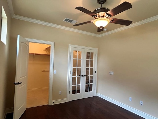 spare room featuring french doors, crown molding, wood finished floors, baseboards, and ceiling fan