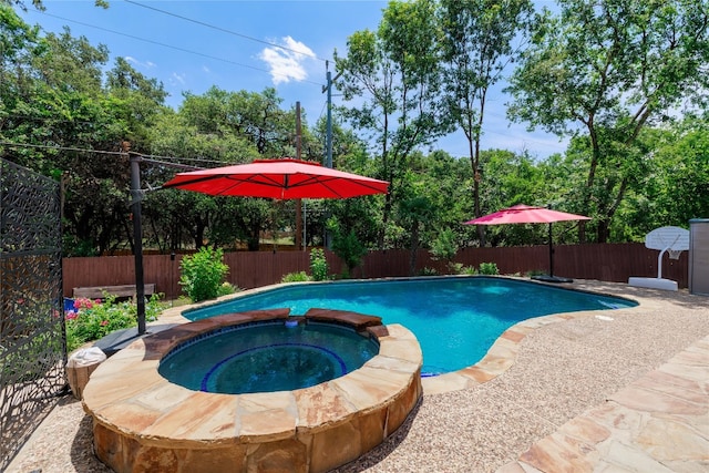 view of pool with a fenced backyard and a pool with connected hot tub