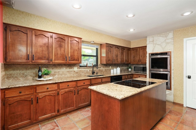 kitchen featuring a center island, decorative backsplash, a sink, light stone countertops, and black appliances