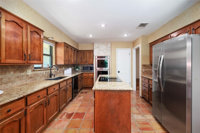 kitchen featuring a kitchen island, a sink, visible vents, decorative backsplash, and black appliances