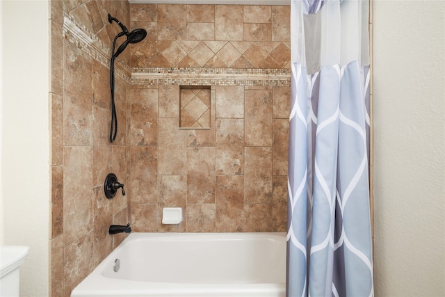 bathroom featuring toilet and shower / bath combo