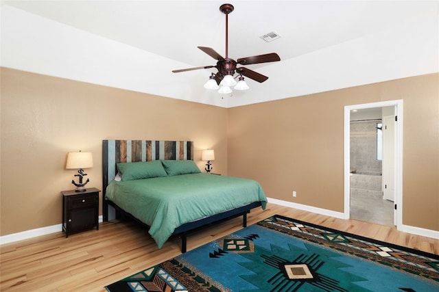 bedroom featuring light wood finished floors, baseboards, and visible vents