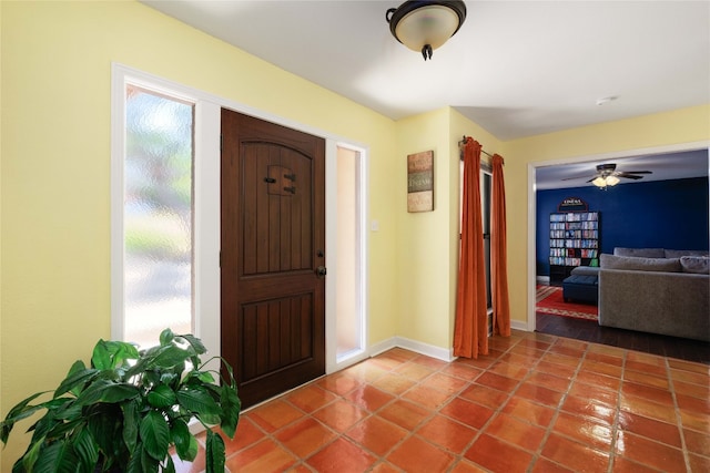 entryway with baseboards and tile patterned floors