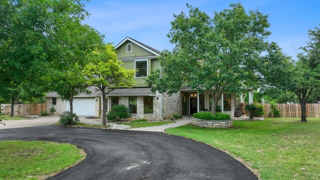 view of front of home with a front yard and a garage