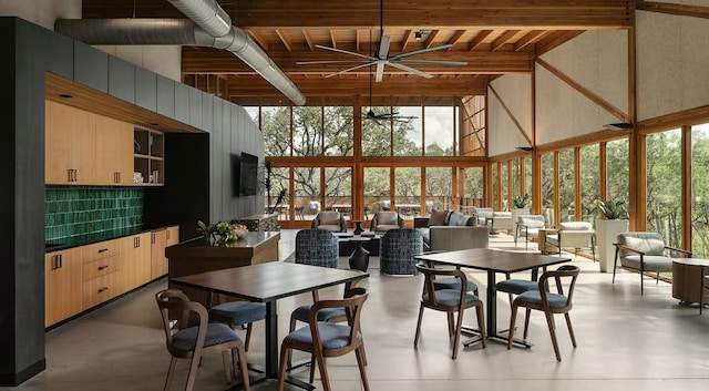 dining space with beamed ceiling, high vaulted ceiling, plenty of natural light, and ceiling fan