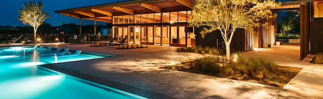 view of pool featuring a hot tub and a patio area