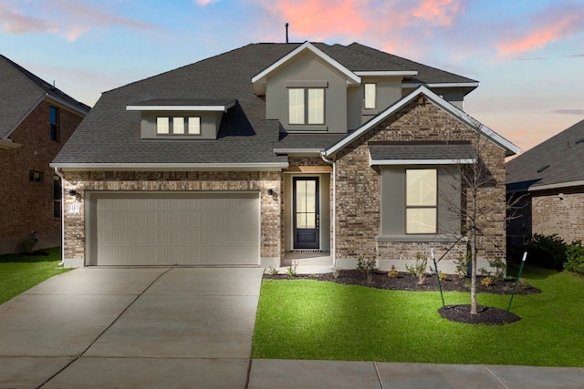 view of front of house with a garage and a yard