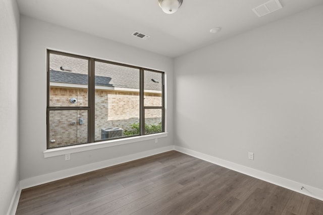 unfurnished room with dark hardwood / wood-style floors