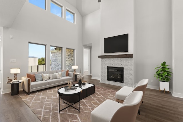 living room featuring wood-type flooring and a towering ceiling