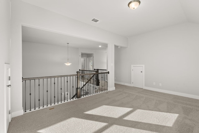 unfurnished room featuring carpet flooring and lofted ceiling