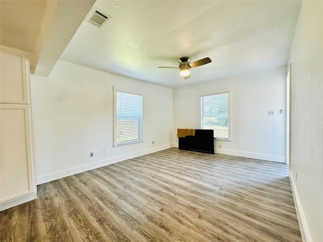 unfurnished living room with ceiling fan and light hardwood / wood-style floors